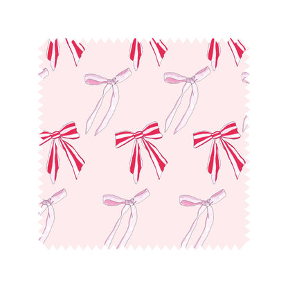 Christmas bows tea towel swatch in pink and red candy stripe bows.