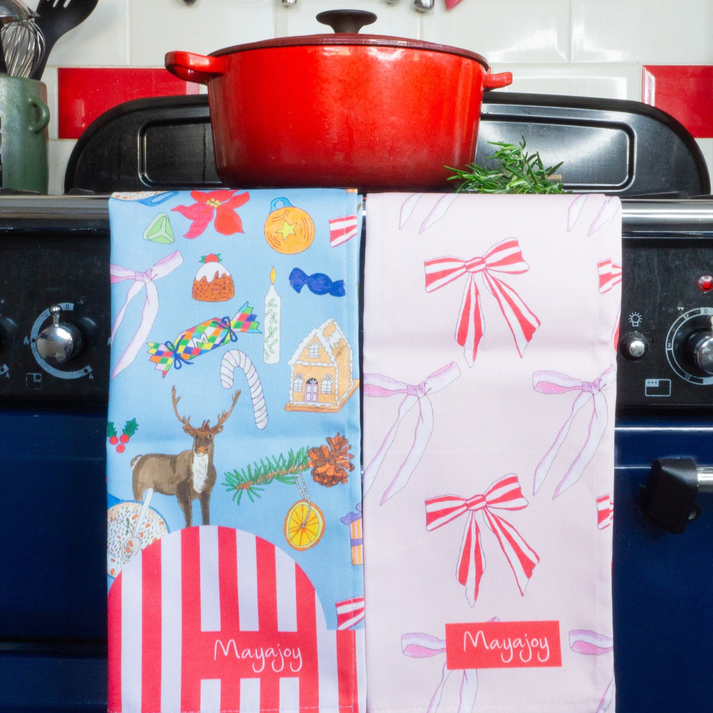 Pair of Christmas cotton tea towels in Christmas nostalgia and Xmas bows. Blue nostalgic hand drawn illustrations and pink candy stripe bows