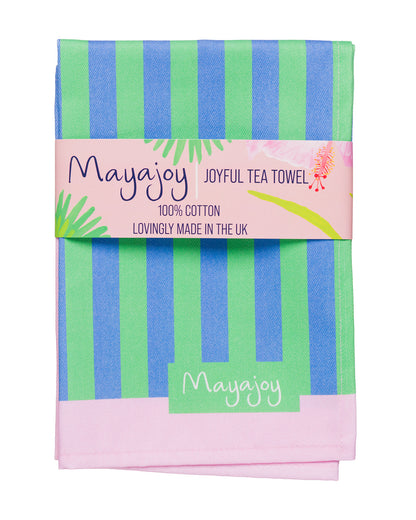 Mayajoy colourful cotton tea towel in Hummingbird stripe design, featuring blue and green stripes with pink border, folded with a coral belly band and words "joyful tea towel".