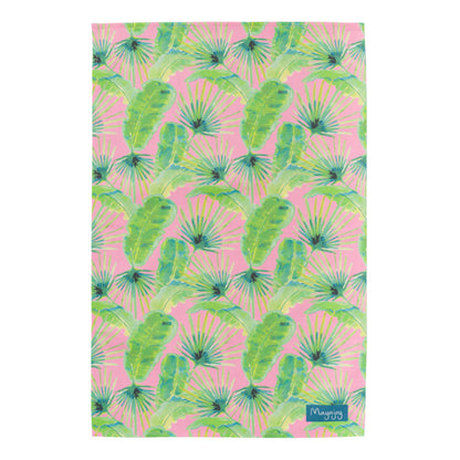 Flat lay colourful cotton tea towel in pink palm design with pink background and hand illustrated green and blue foliage with hanging loop by Mayajoy 
